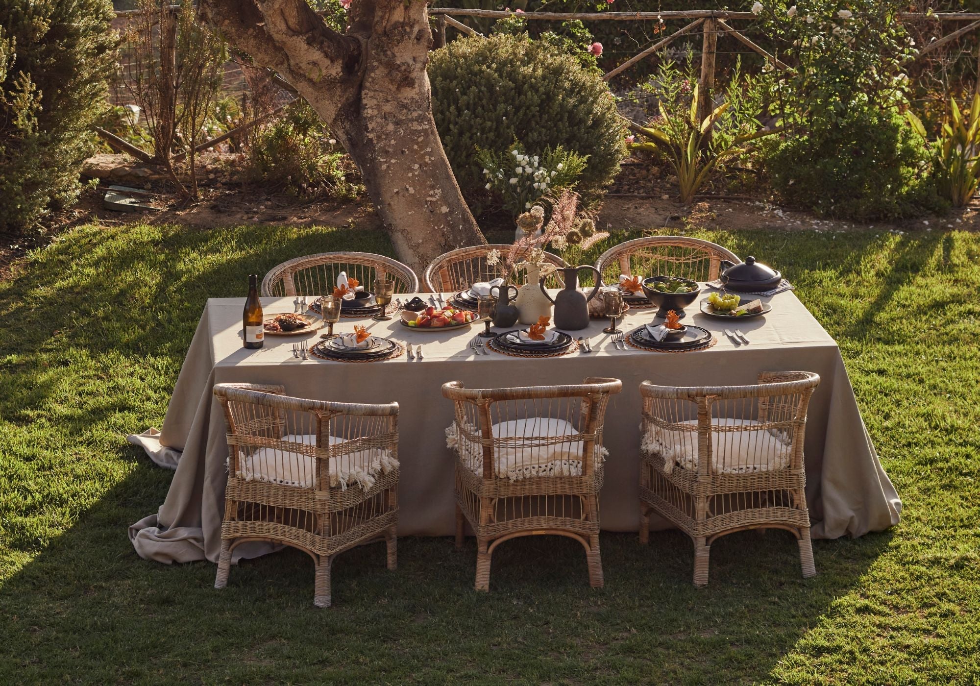 Garden Party table setup with with handwoven placemats and hand painted plates
