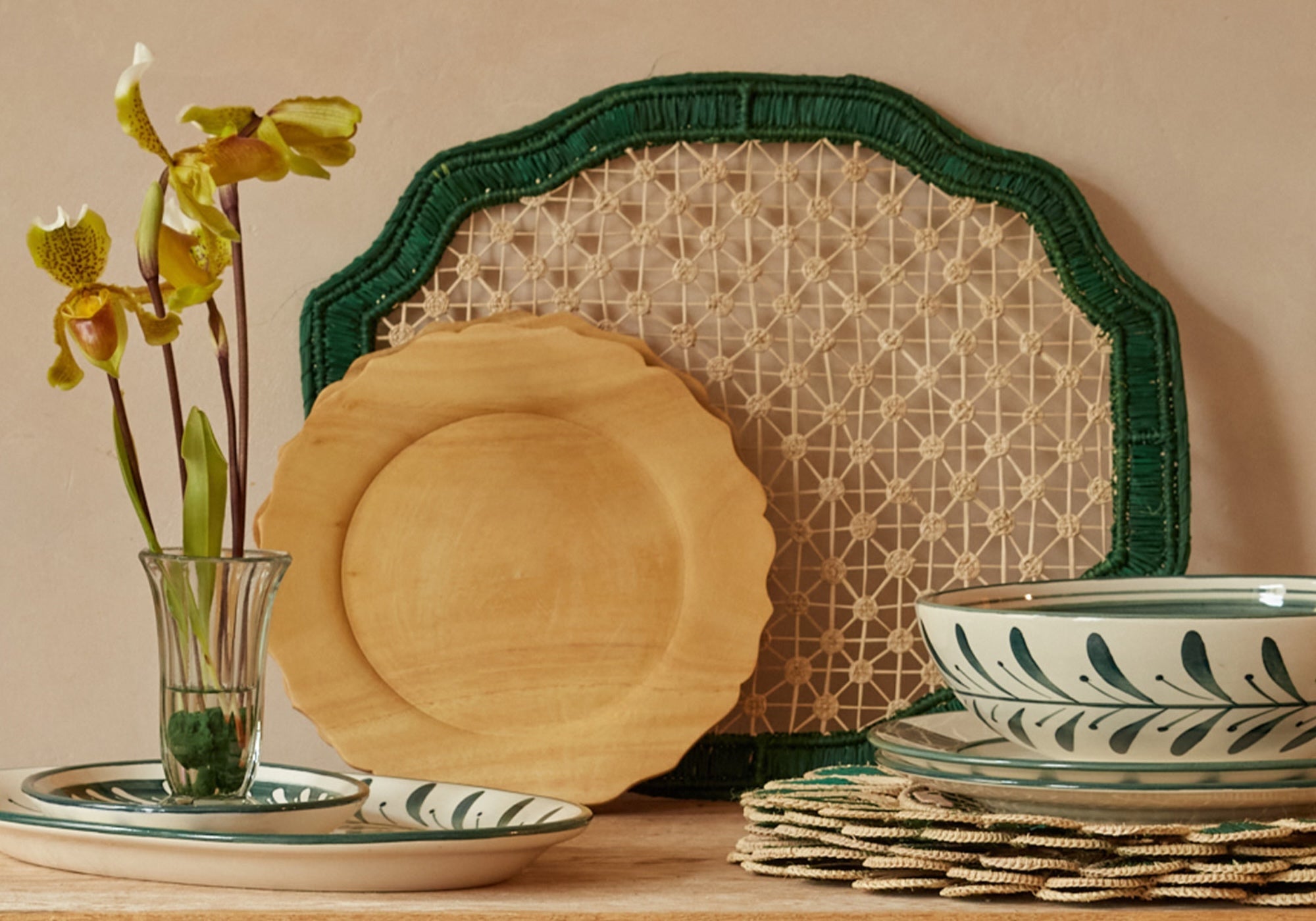 Spring cut flowers and green homeware on a vintage wood table