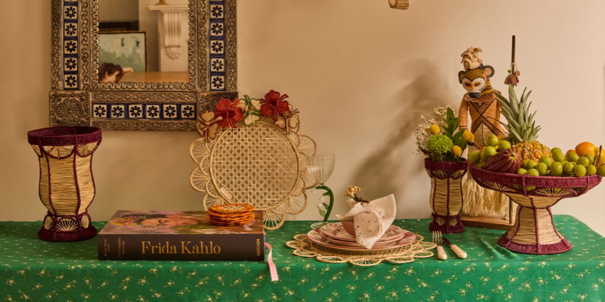 Hand-painted floral ceramic plates and bowls with handwoven palm tableware in bold Frida Kahlo-inspired colours