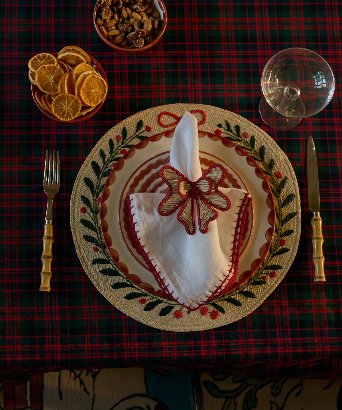 Embroidered Festive Placemat on a Christmas table, layered with hand-painted ceramics