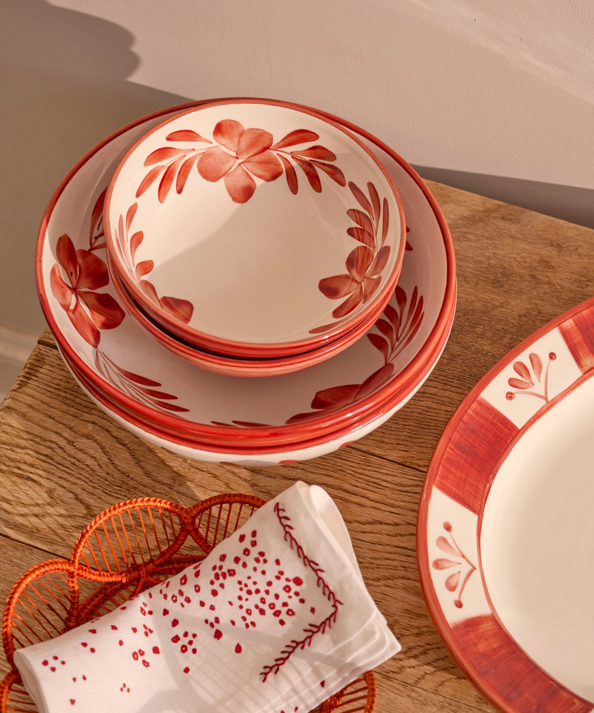 Rust Red Flor large salad bowl on the table, hand-painted floral ceramic from Carmen del Viboral