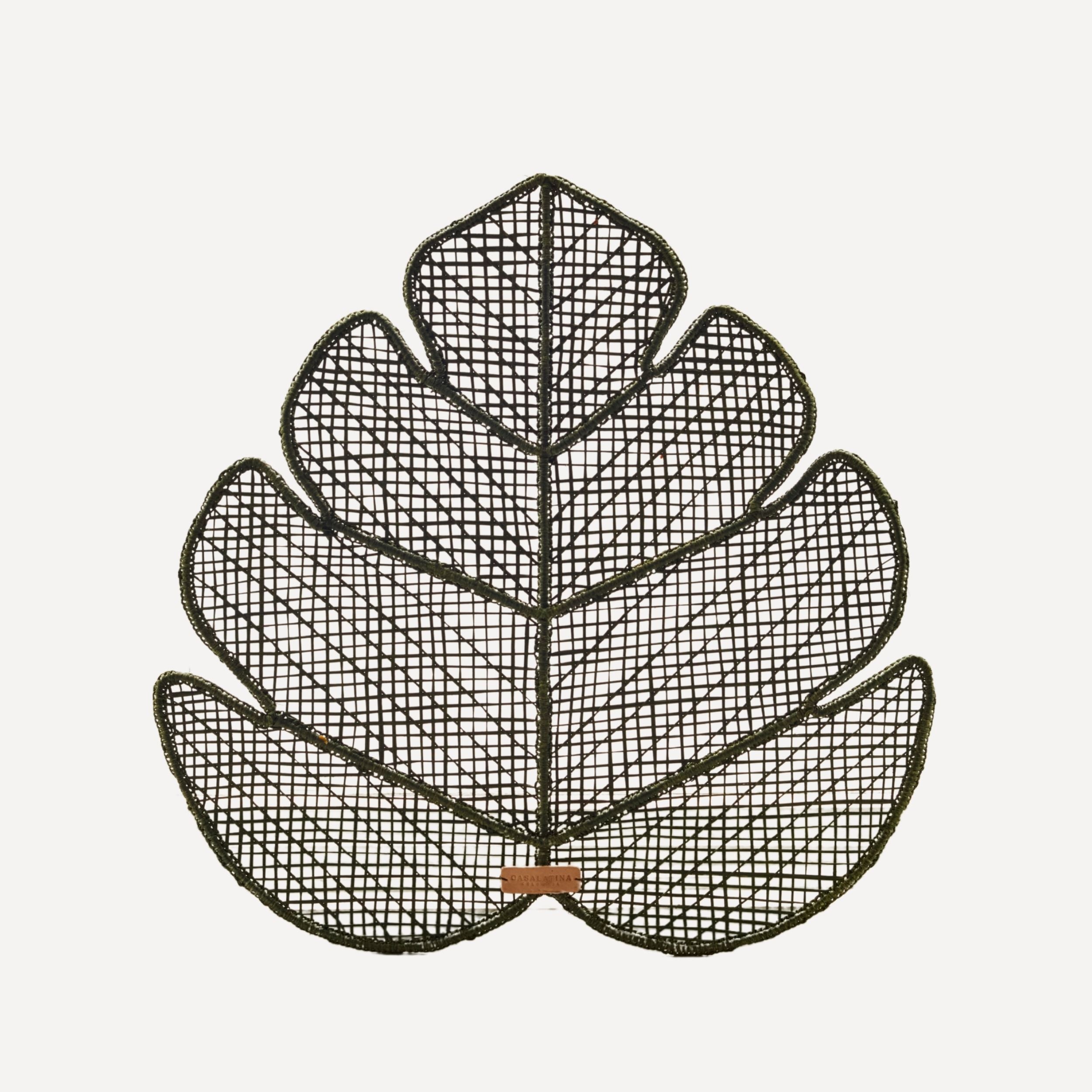 Decorative leaf-shaped handwoven Iraca placemat on a white background