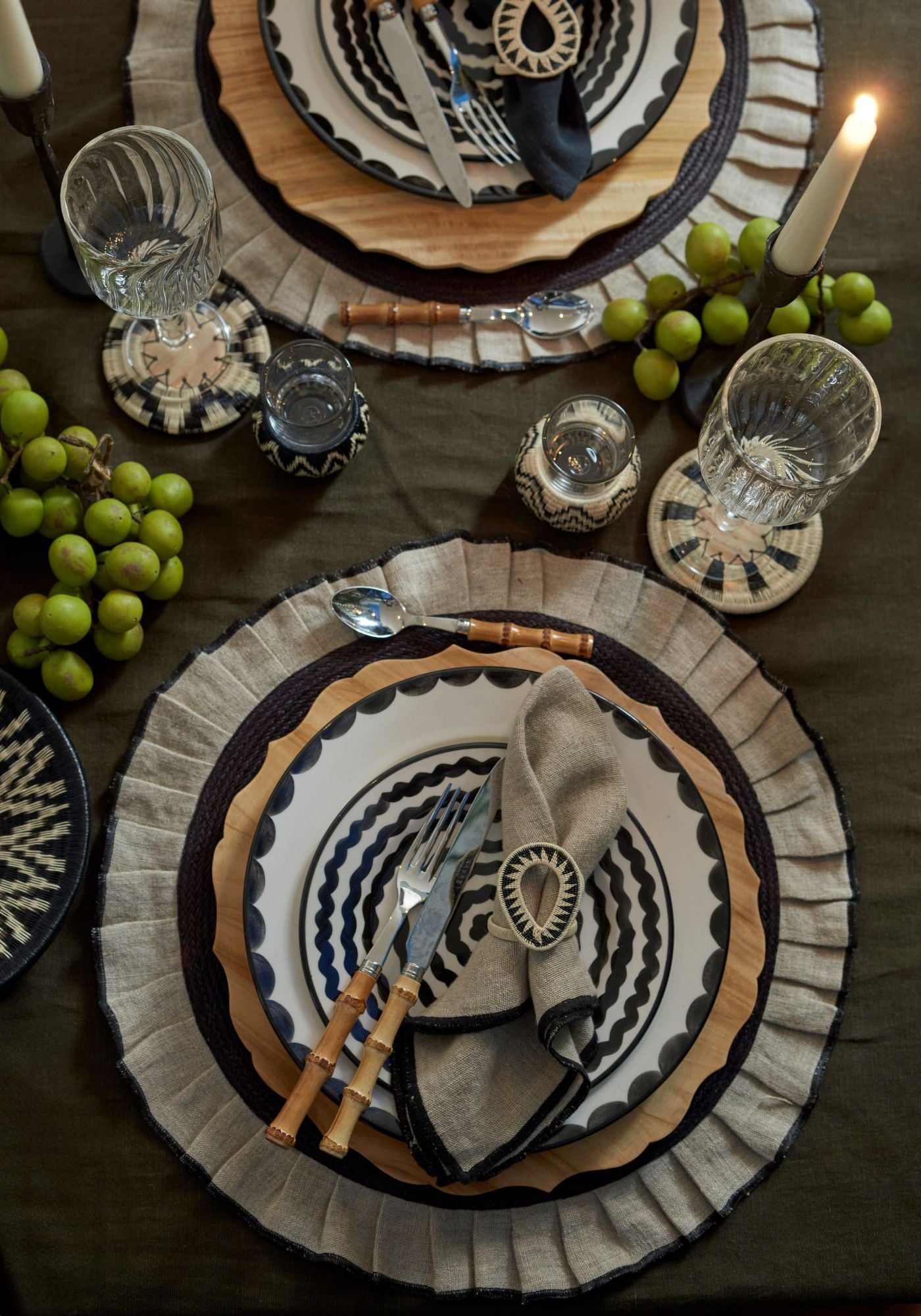 Dinner for Two tablescape with monochrome hand-painted ceramics, natural linen, bamboo cutlery, and werregue woven accessories styled for an intimate dinner setting.