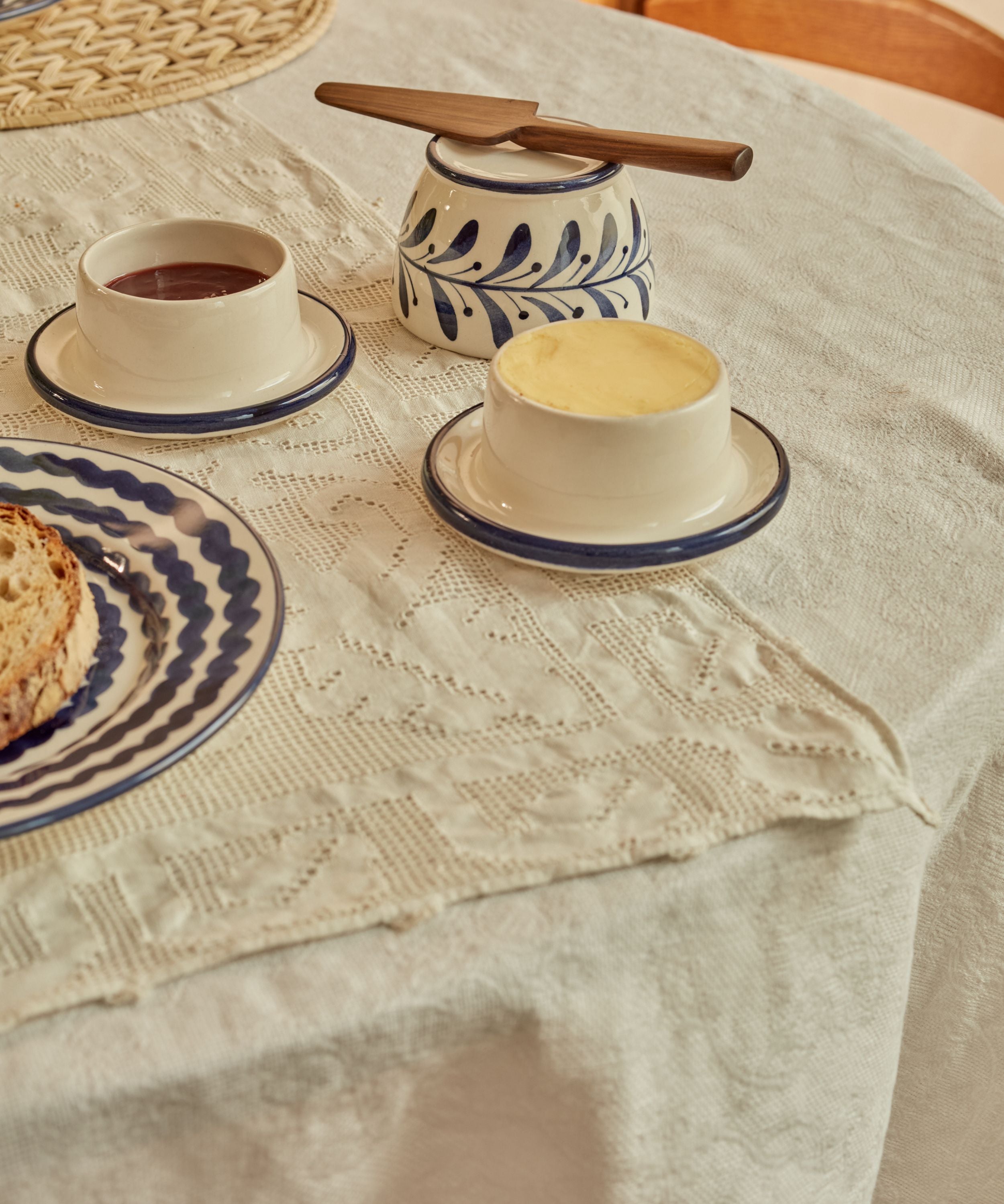 Hand-painted Helecho French butter dish in Deep Blue styled in a table setting, showing the fern wreath ceramic from Carmen del Viboral, Colombia.