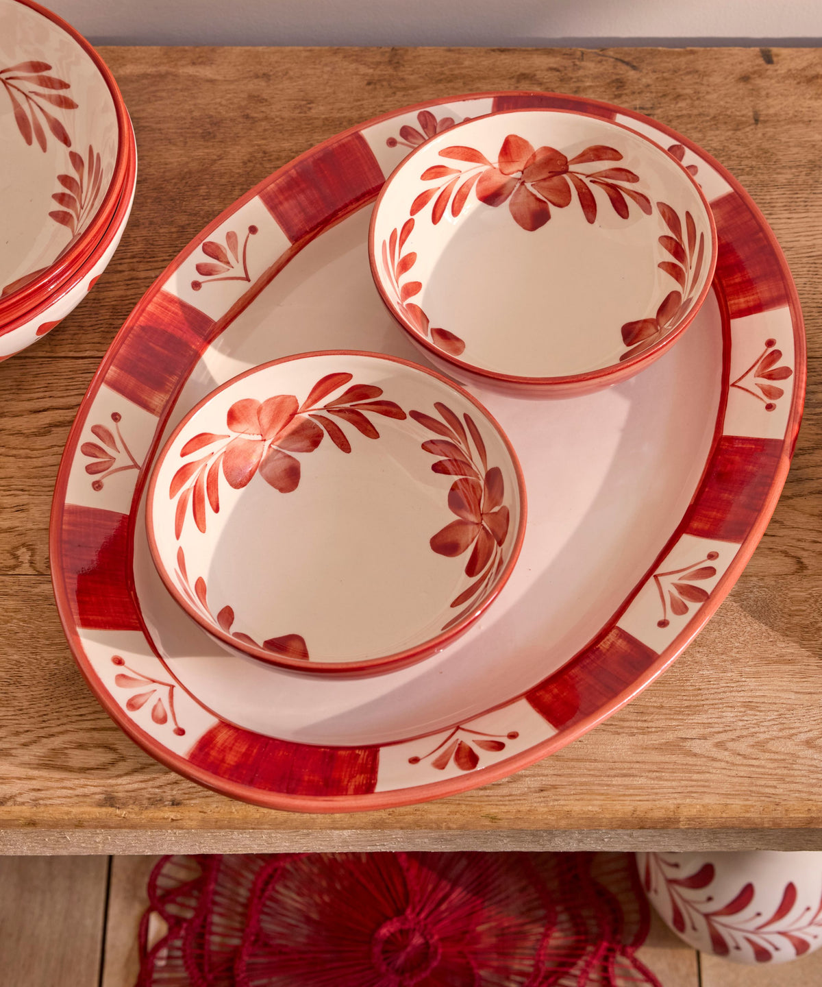 Rust Red Flor de Lis extra large serving platter on the table, hand-painted floral ceramic
